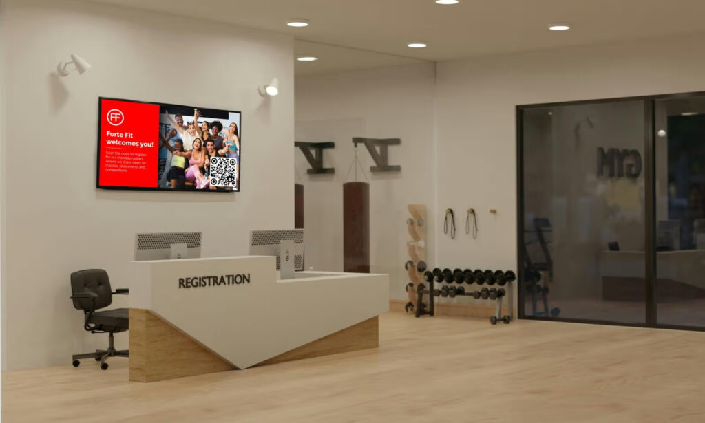 welcome board digital signage at a fitness center reception